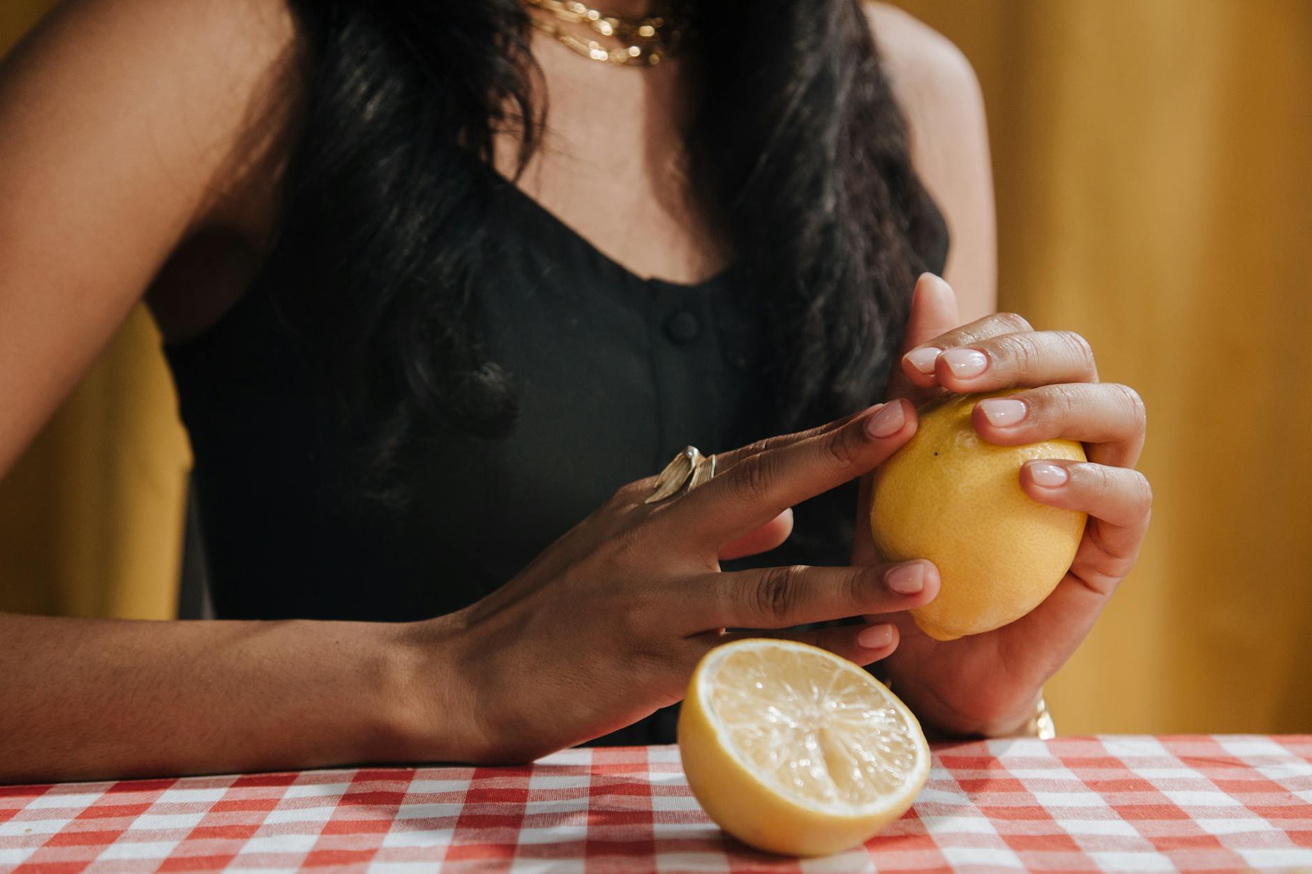 Woman holding fresh lemon, representing natural vitality and pleasure at any age